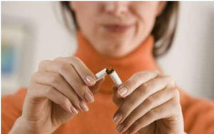 woman breaking a cigarette in half