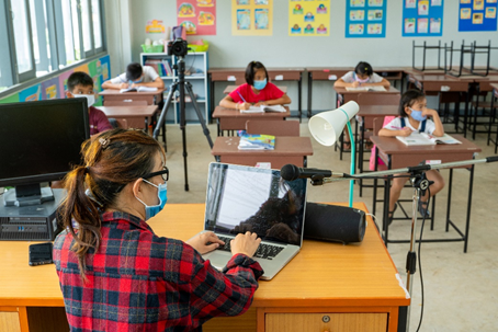 Teacher wearing mask  in classroom