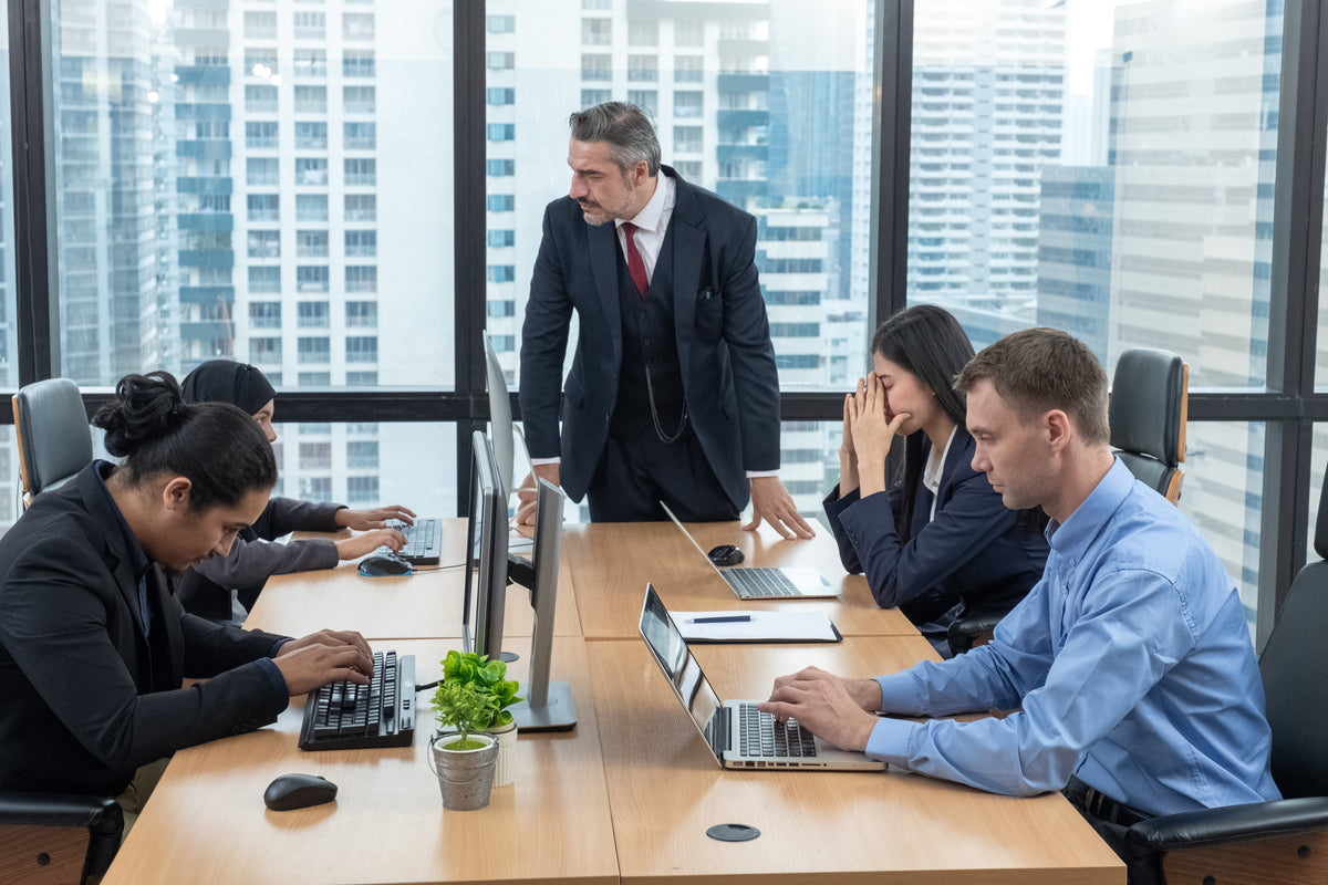 Moody boss complaining team about the mistake. Businessman managers pointing out mistakes to their team. Toxic work environment.