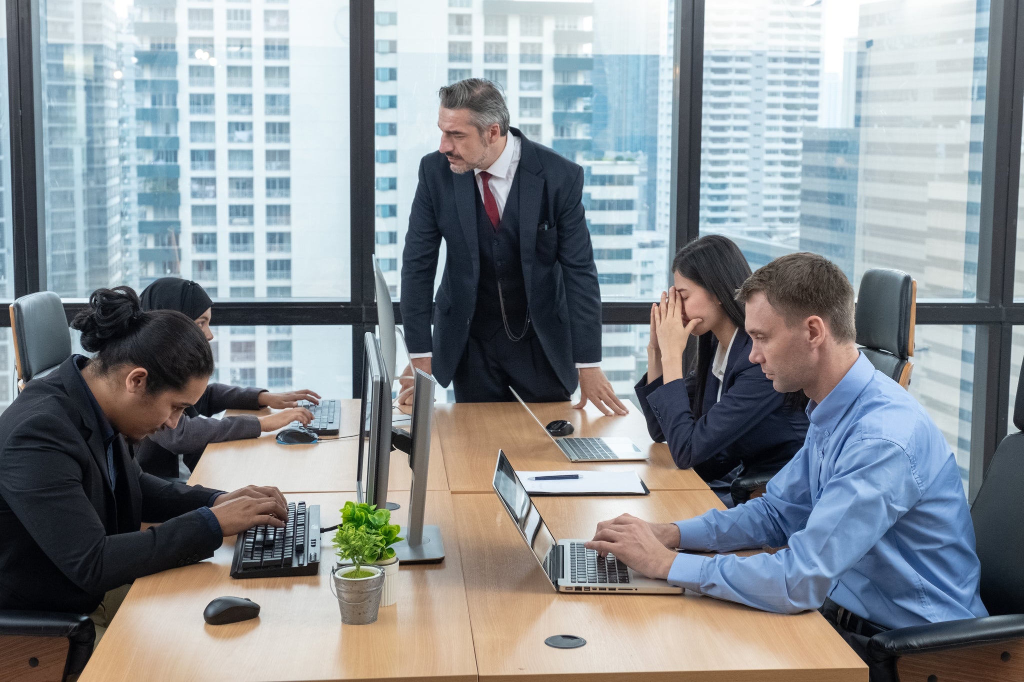 Moody boss complaining team about the mistake. Businessman managers pointing out mistakes to their team. Toxic work environment.