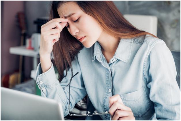 Woman at computer looking stressed