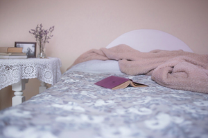 Bed with blankets and a book