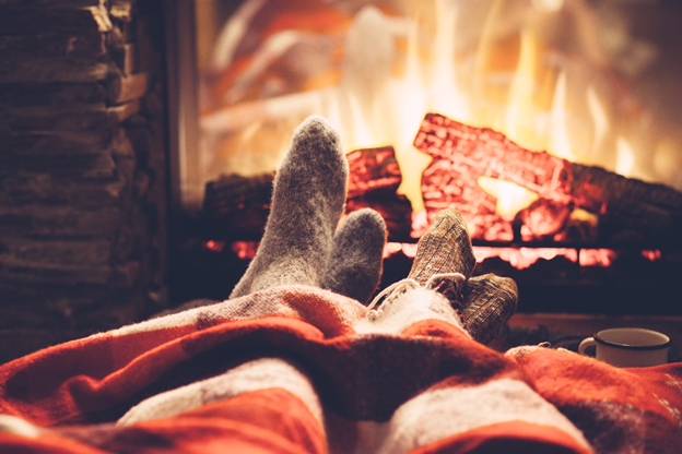 Couples feet in front of cozy fireplace 