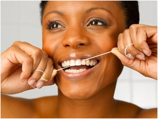 woman flossing her teeth