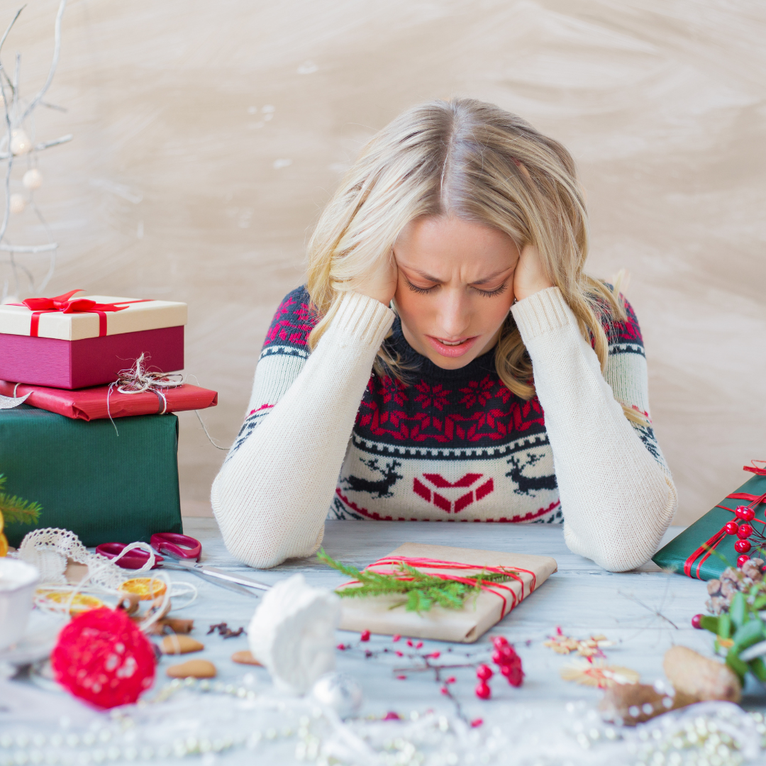 woman looking stressed wrapping gifts