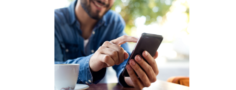 young man opening an app on his phone