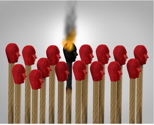 Book of matches that look like faces, one is on fire.