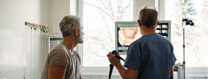 man getting medical test results from doctor