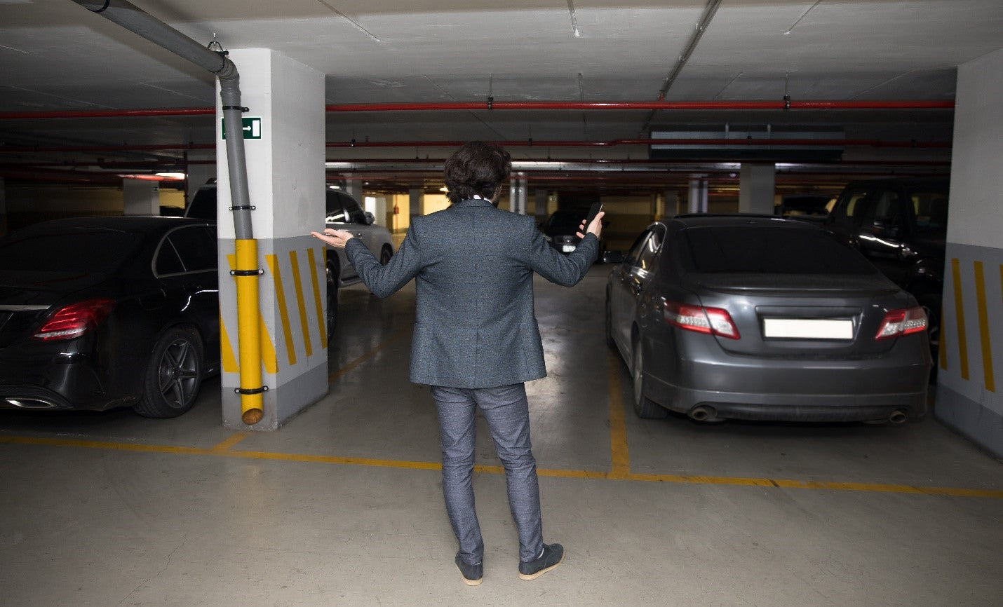 Man looking for car in parking garage