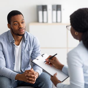 Man sitting talking to a counselor