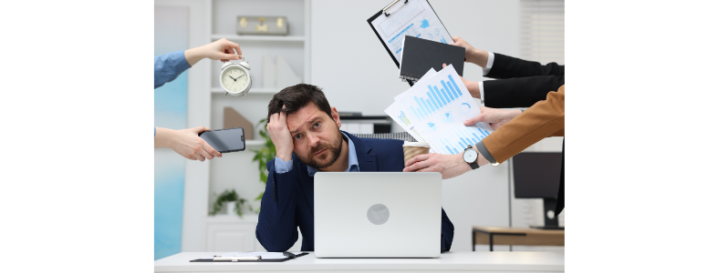 Composed but overwhelmed employee at desk