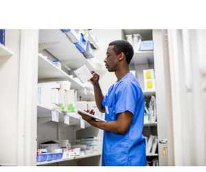 Man in supplies closet checking inventory