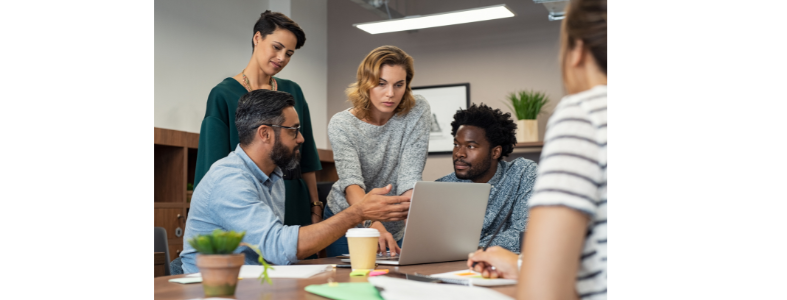 a group of people working together on a computer